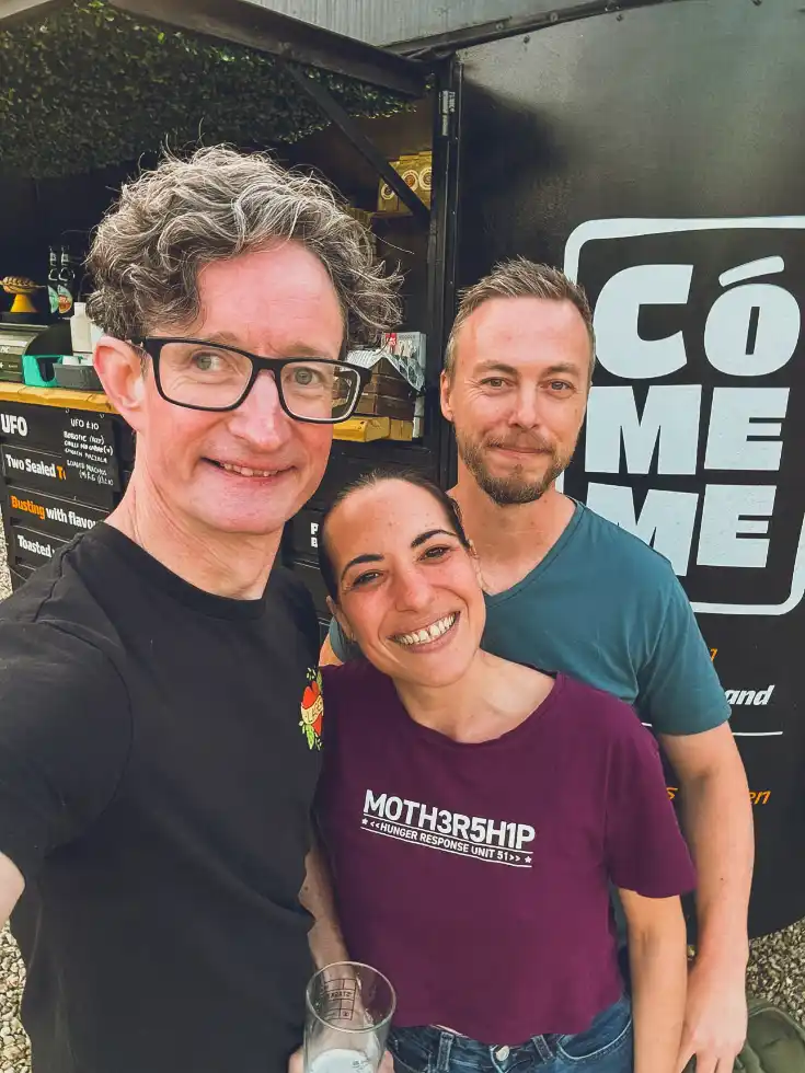 James, Ari and Nick smiling outside the CóMeme horsebox.